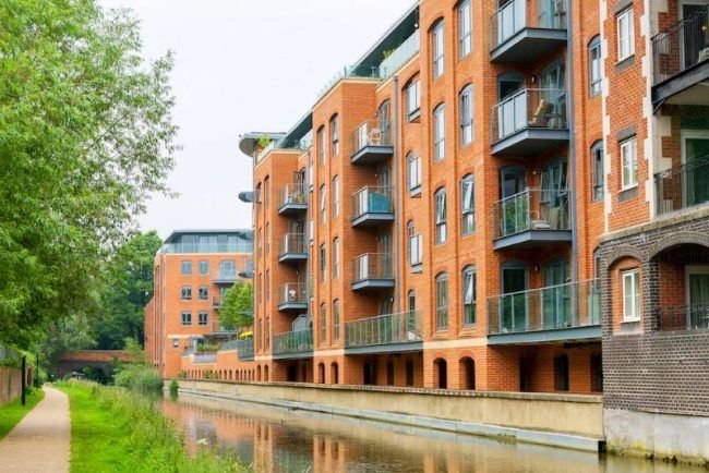 A photo of apartment buildings overlooking a canal in the UK.