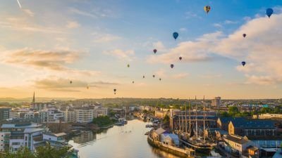 A photo of hot-air balloons flying over the city centre of Bristol
